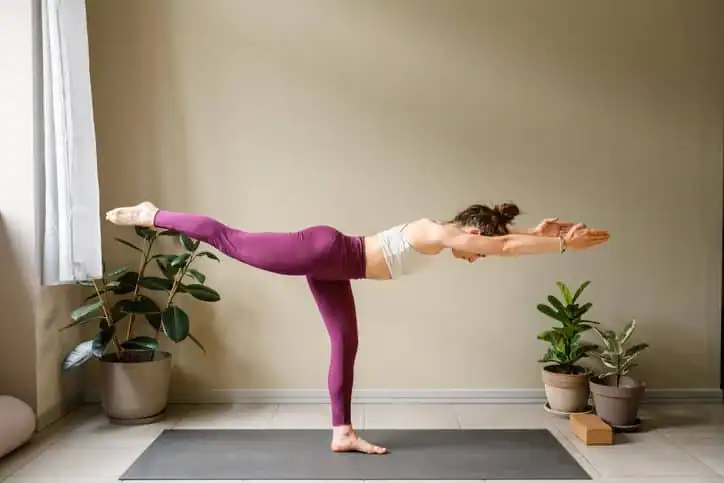Woman doing Yoga exercise Ashford to help with toning the body. 