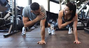 Image of man and woman doing Cardio Ashford to tone their arms. 